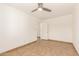 Bright bedroom featuring neutral tile flooring and a ceiling fan at 7231 W Sierra Vista Dr, Glendale, AZ 85303