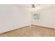 A sunlit bedroom offers neutral tile flooring and ceiling fan at 7231 W Sierra Vista Dr, Glendale, AZ 85303
