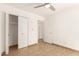 Bright bedroom featuring neutral tile flooring and a ceiling fan at 7231 W Sierra Vista Dr, Glendale, AZ 85303
