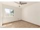 A bright bedroom featuring neutral tile flooring and a ceiling fan at 7231 W Sierra Vista Dr, Glendale, AZ 85303