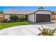 Charming single-story home with a well-manicured lawn and attached two-car garage on a sunny day at 7231 W Sierra Vista Dr, Glendale, AZ 85303
