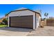 View of an attached two-car garage on a single-story home with a well-maintained driveway at 7231 W Sierra Vista Dr, Glendale, AZ 85303