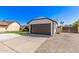 View of an attached two-car garage on a single-story home with a well-maintained driveway at 7231 W Sierra Vista Dr, Glendale, AZ 85303