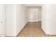 Hallway featuring neutral-colored tile flooring and white walls at 7231 W Sierra Vista Dr, Glendale, AZ 85303