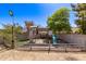 Backyard featuring a charming playhouse, a playset area, and green grass, creating an inviting space for outdoor activities at 7231 W Sierra Vista Dr, Glendale, AZ 85303
