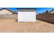 Backyard showcasing a practical shed, ample yard space, and a secure fenced perimeter, offering storage and privacy at 7231 W Sierra Vista Dr, Glendale, AZ 85303