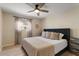 Cozy bedroom with a ceiling fan, large window, and a well-dressed bed with decorative pillows at 782 W Gail Dr, Chandler, AZ 85225