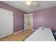 Bedroom featuring a large closet and hardwood floors, complemented by a light purple wall at 782 W Gail Dr, Chandler, AZ 85225