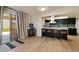 Modern kitchen featuring a breakfast bar, stainless steel appliances, and sliding door access to the outdoors at 782 W Gail Dr, Chandler, AZ 85225