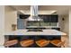 A modern kitchen island with an integrated cooktop and seating for four at 782 W Gail Dr, Chandler, AZ 85225