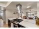 A modern kitchen island with a stainless steel vent hood open to the living area at 782 W Gail Dr, Chandler, AZ 85225