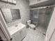 Stylish bathroom featuring patterned tile, a modern vanity, and a glass-enclosed shower at 7903 N 61St Ave, Glendale, AZ 85301