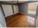 Comfortable bedroom featuring hardwood floors, a ceiling fan, two large closets, and a window at 7903 N 61St Ave, Glendale, AZ 85301