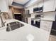 Contemporary kitchen design showcasing stainless steel appliances and a quartz countertop at 7903 N 61St Ave, Glendale, AZ 85301