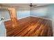 Spacious living room with hardwood flooring, fan, and views leading down the hallway at 7903 N 61St Ave, Glendale, AZ 85301
