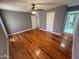 Large main bedroom with hardwood floors, fan, and ensuite bathroom, and two closets at 7903 N 61St Ave, Glendale, AZ 85301