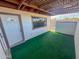 Enclosed patio with green turf, window, and door, perfect for outdoor relaxation and privacy at 7903 N 61St Ave, Glendale, AZ 85301