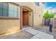 Close up of the front door with neutral toned paint and stonework at 8113 W Groom Creek Rd, Phoenix, AZ 85043