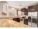 Kitchen featuring stainless steel appliances, dark cabinets, and light countertops at 8113 W Groom Creek Rd, Phoenix, AZ 85043