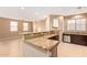 Open floor plan with granite kitchen bar, tile flooring, and ample natural light at 8113 W Groom Creek Rd, Phoenix, AZ 85043