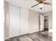 This bedroom features a ceiling fan, wood floors, closet, and a door to another room at 8433 E Natal Cir, Mesa, AZ 85209