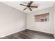 Empty bedroom with a ceiling fan, light walls, and laminate flooring at 8433 E Natal Cir, Mesa, AZ 85209