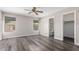 Spacious bedroom with laminate flooring, two windows and ceiling fan, and ensuite bathroom at 8433 E Natal Cir, Mesa, AZ 85209