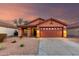 Charming single-story home with a two-car garage, neutral desert landscaping and a warm, inviting exterior at 8433 E Natal Cir, Mesa, AZ 85209