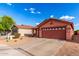 Well-kept single-story home with a two-car garage, minimal desert landscaping, and a welcoming front facade at 8433 E Natal Cir, Mesa, AZ 85209