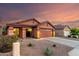 Inviting single-story home with low-maintenance landscaping, a two-car garage, and a warm, welcoming facade at 8433 E Natal Cir, Mesa, AZ 85209