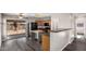 Bright kitchen with stainless steel appliances and an island, and sliding glass doors to the backyard patio at 8433 E Natal Cir, Mesa, AZ 85209