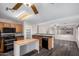 Open concept kitchen, featuring oak cabinets, granite counters, black appliances, and a butcher block island at 8433 E Natal Cir, Mesa, AZ 85209