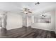 Spacious living room with wood-look floors, a ceiling fan, and a light, neutral color palette at 8433 E Natal Cir, Mesa, AZ 85209