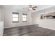 Open living area with wood-look floors, neutral walls, lots of natural light, and a ceiling fan at 8433 E Natal Cir, Mesa, AZ 85209