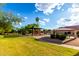 Community playground with covered play structures, picnic tables, and grassy areas with mature trees under a sunny sky at 8433 E Natal Cir, Mesa, AZ 85209