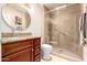 Well-lit bathroom features an updated glass shower and granite vanity countertop at 8818 N 47Th Ln, Glendale, AZ 85302