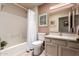 Cozy bathroom with a shower-tub combo and a neutral colored vanity at 8818 N 47Th Ln, Glendale, AZ 85302