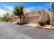 Charming townhomes feature private garages, desert landscaping, and stucco facades under a sunny blue sky at 8818 N 47Th Ln, Glendale, AZ 85302