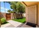 Welcoming front entrance with artificial turf, secure gate, and stylish security screen door at 8818 N 47Th Ln, Glendale, AZ 85302