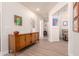 Inviting hallway with wood-look floors and a stylish sideboard at 8818 N 47Th Ln, Glendale, AZ 85302