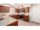 Well-lit kitchen features granite counters, stainless appliances, and wood cabinetry at 8818 N 47Th Ln, Glendale, AZ 85302