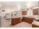 Open kitchen features stainless steel appliances, granite countertops, and warm wood cabinets at 8818 N 47Th Ln, Glendale, AZ 85302