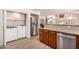 Open kitchen features stainless appliances, granite countertops, and adjacent laundry area at 8818 N 47Th Ln, Glendale, AZ 85302
