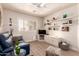 Comfortable living room with blue sofa, ottoman, and open shelving at 8818 N 47Th Ln, Glendale, AZ 85302