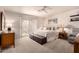 Serene main bedroom with plush carpeting, ceiling fan, and sliding glass doors at 8818 N 47Th Ln, Glendale, AZ 85302