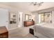 Bright main bedroom with modern ceiling fan, patio access and en-suite bath at 8818 N 47Th Ln, Glendale, AZ 85302