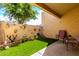 Enclosed patio area showcasing desert landscaping and artificial grass at 8818 N 47Th Ln, Glendale, AZ 85302