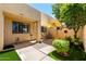 Relaxing walled patio with umbrella, outdoor seating, manicured bushes, and artificial turf at 8818 N 47Th Ln, Glendale, AZ 85302