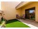 Private patio features artificial turf and desert landscaping at 8818 N 47Th Ln, Glendale, AZ 85302