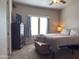 Bright bedroom featuring a ceiling fan, a window and a TV on top of the wooden dresser at 8865 E Baseline Rd # 614, Mesa, AZ 85209